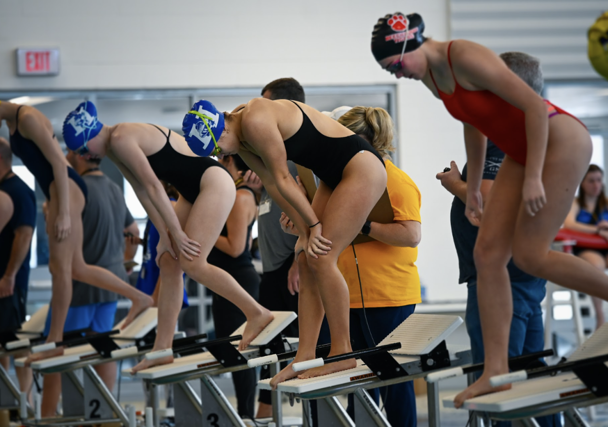 Ragan Moore (11) prepares to dive into the water for her 50 yard freestyle. 